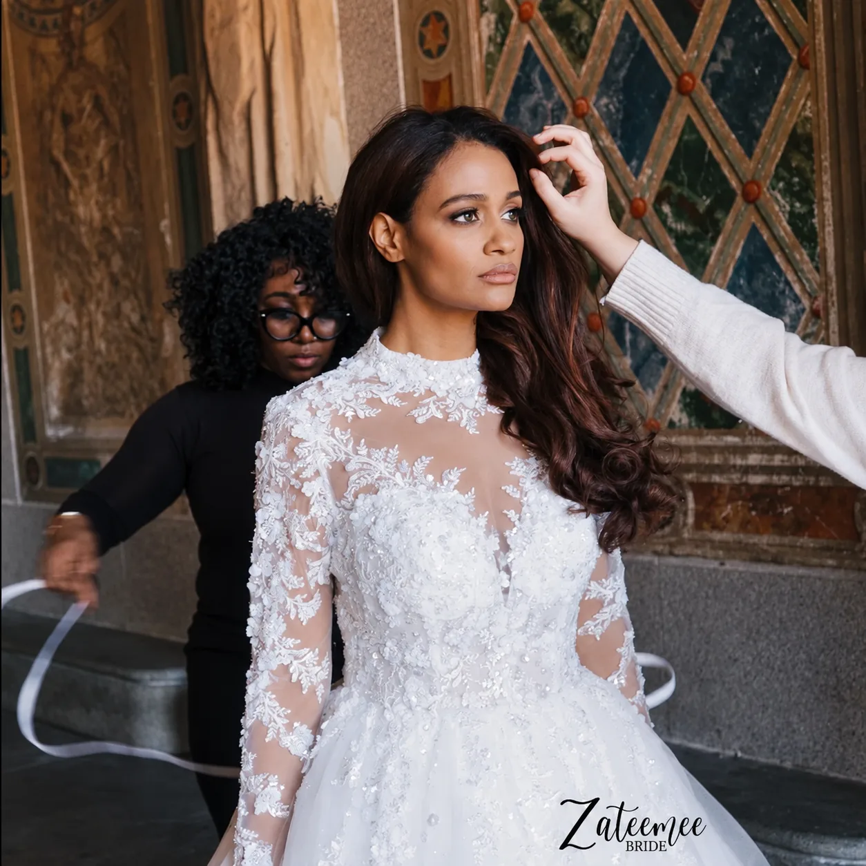 Mercy adjusting a bride’s gown in the atelier