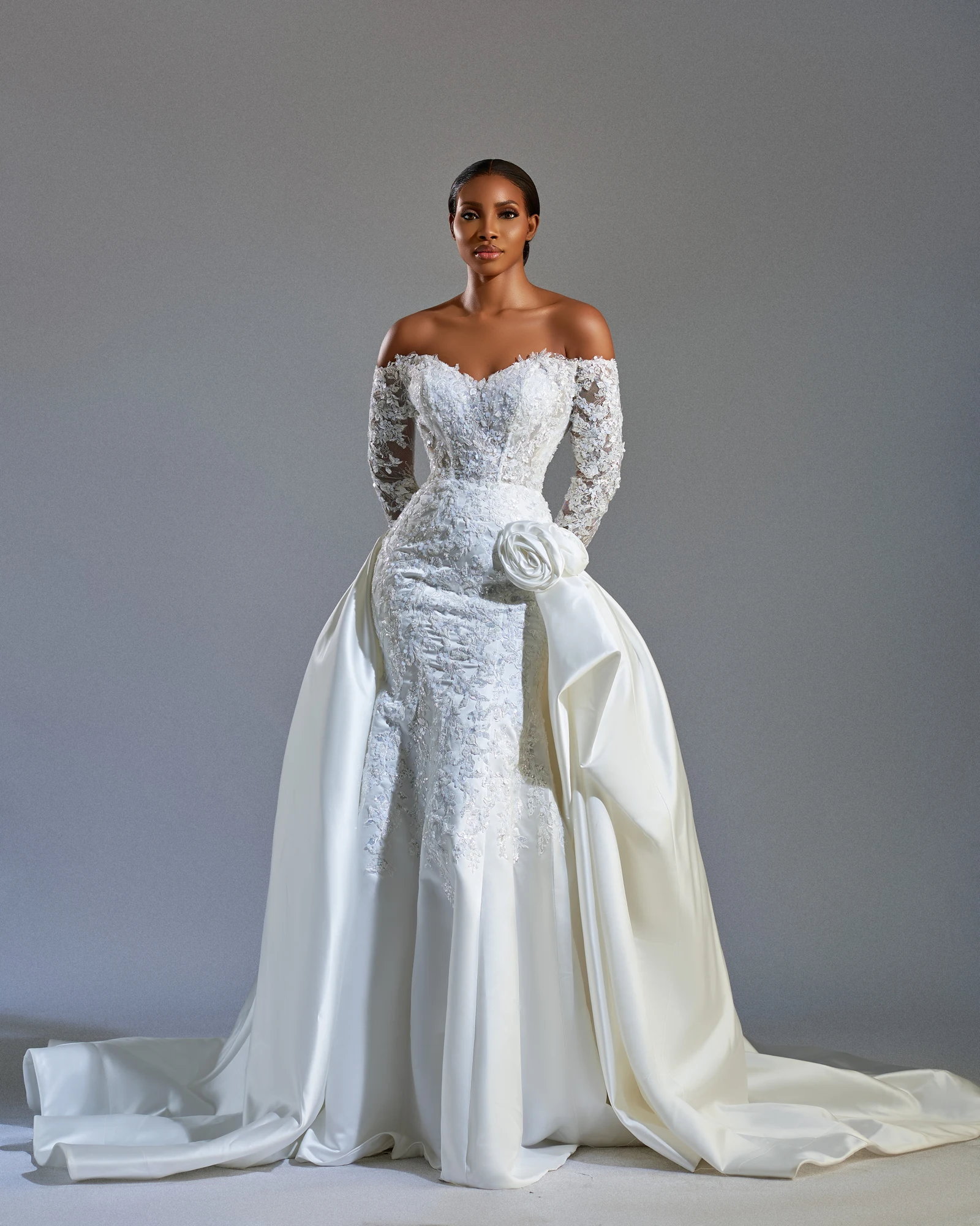 Esther lace bridal gown against a soft gray studio background